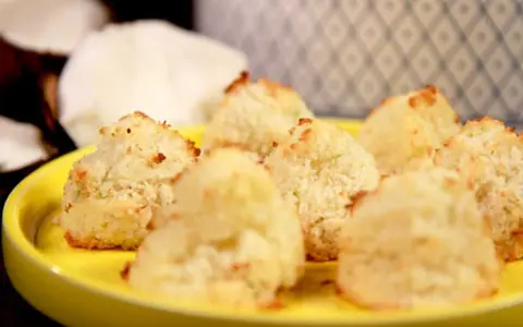 Gyllene kokostoppar på en gul tallrik, perfekta för ett enkelt kokostoppar recept.