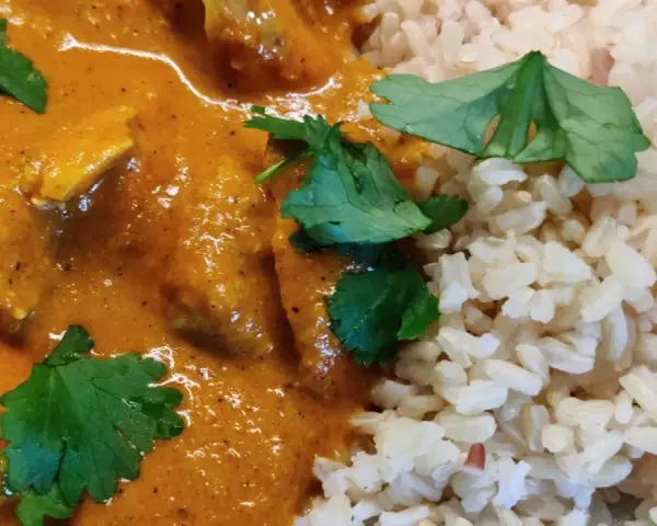 En krämig kycklingrätt med ris, perfekt för ett snabbt tikka masala recept. Garnerad med färsk koriander.