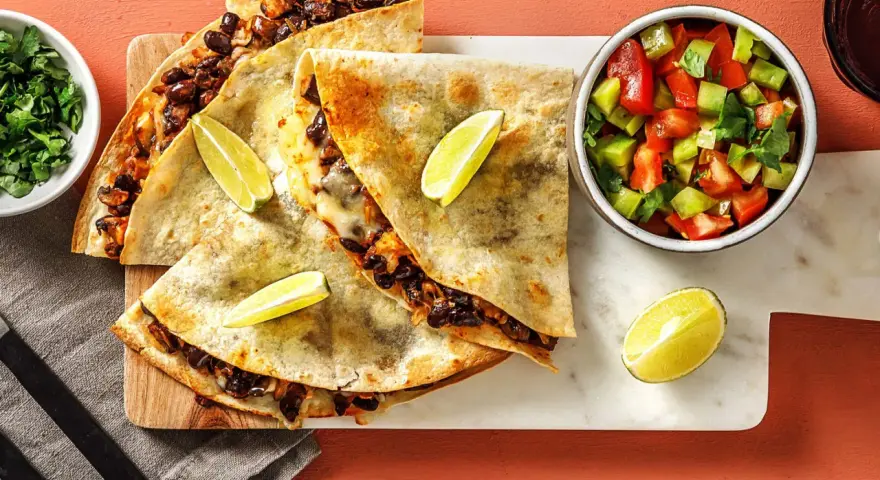 Läckra quesadillas med svarta bönor och ost, serverade med salsa och lime. Ett perfekt quesadillas recept för en snabb och smakrik måltid.