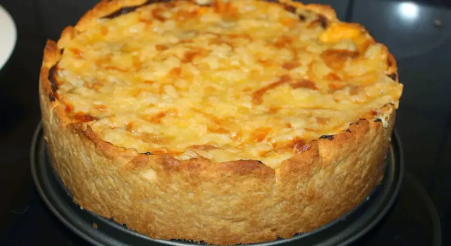 En gyllene kycklingpaj med ostigt täcke, perfekt för ett mysigt kycklingpaj recept.